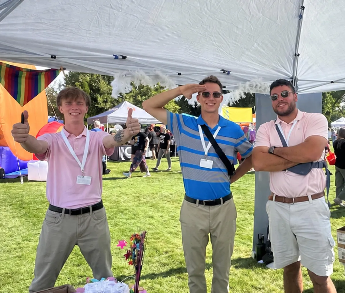 Three Iron Bloom team members under the team tent at Boise Pride