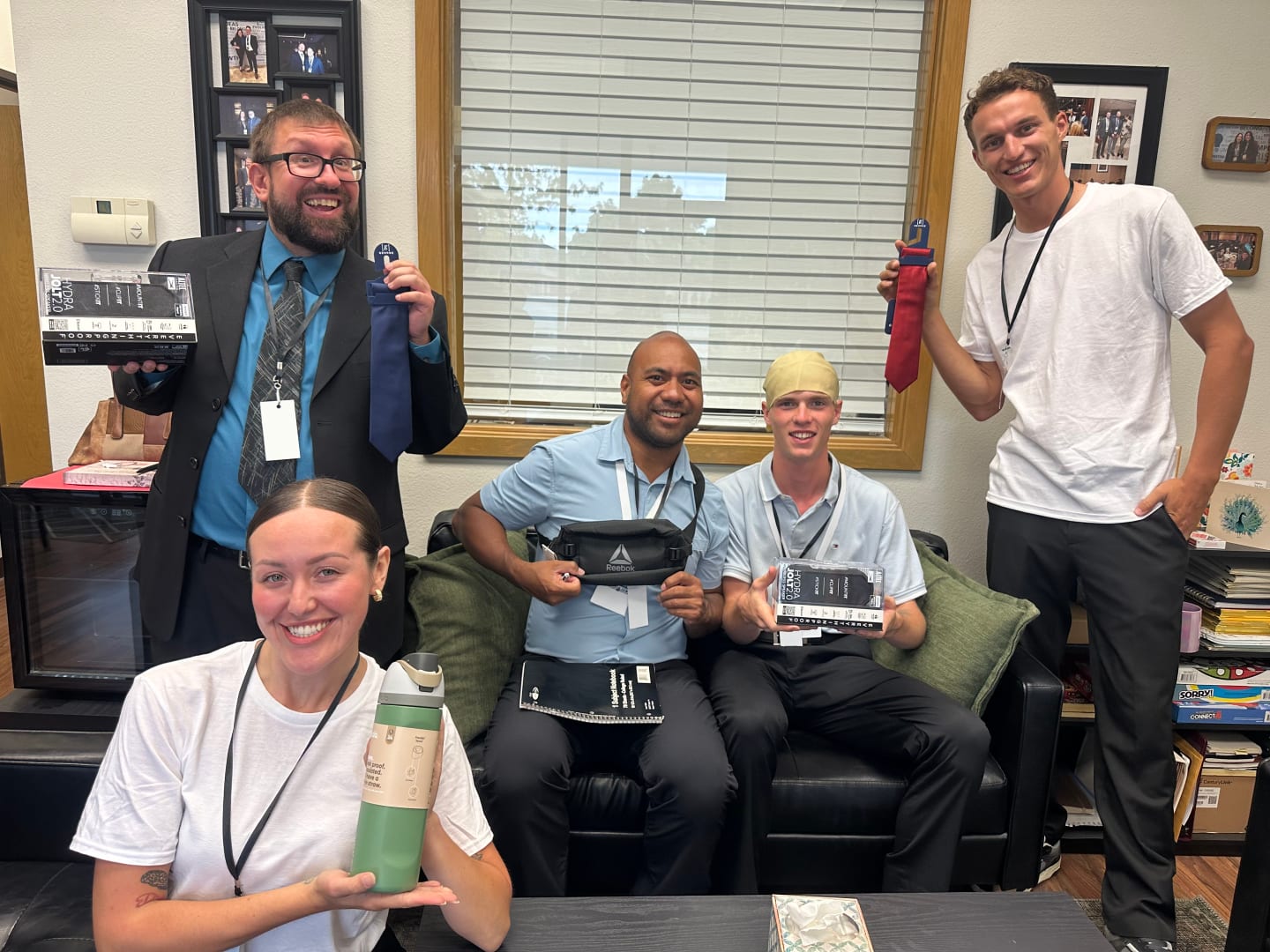 The raffle winners: five Iron Bloom team members in the office, smiling and holding up their prizes